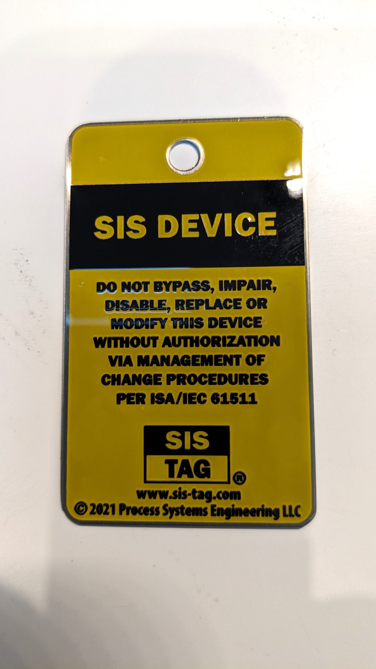 SIS-TAG in yellow and black, stainless steel, 1.5” x 2.5”